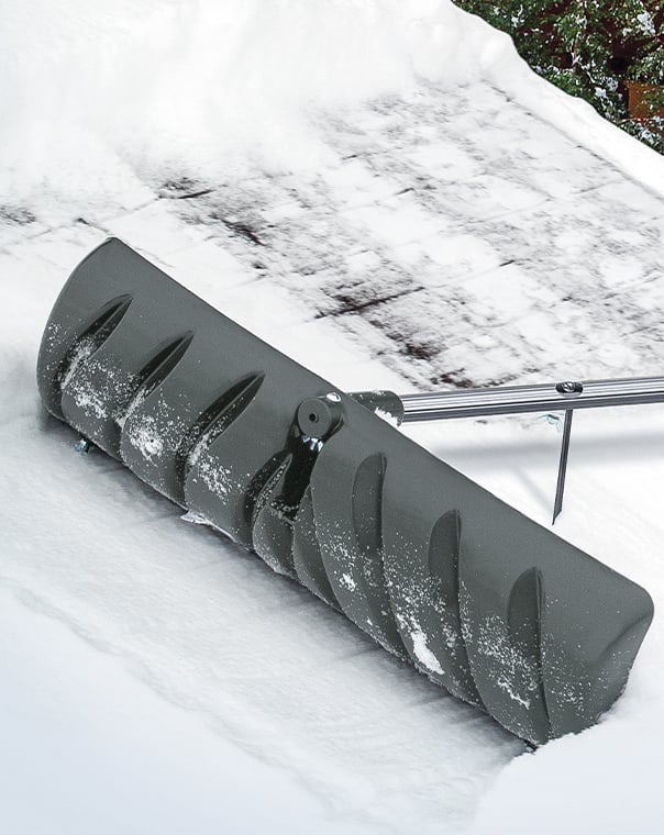 Person using a specialty roof snow removal tool